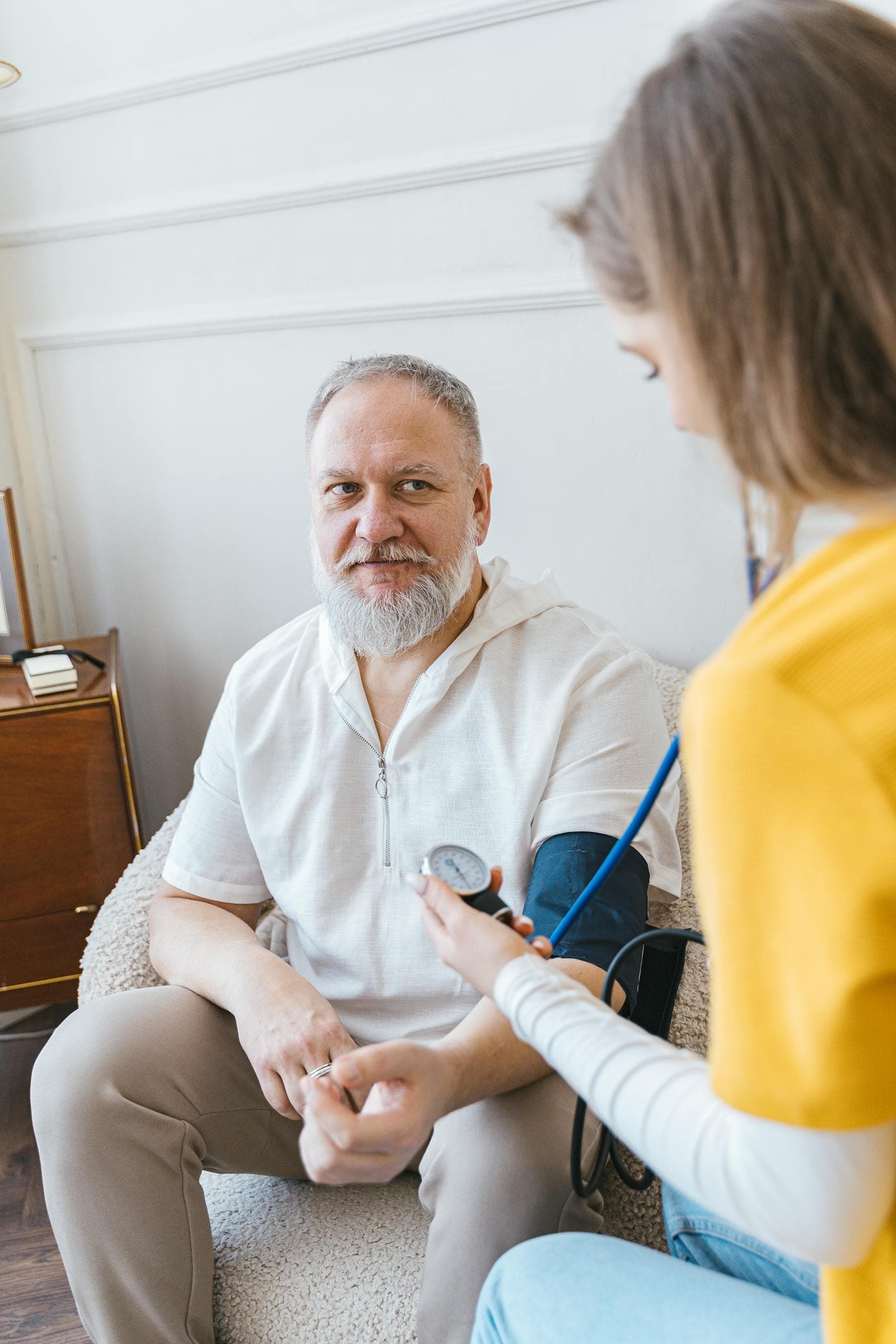 Senior receiving attentive care and wellness support during a home visit